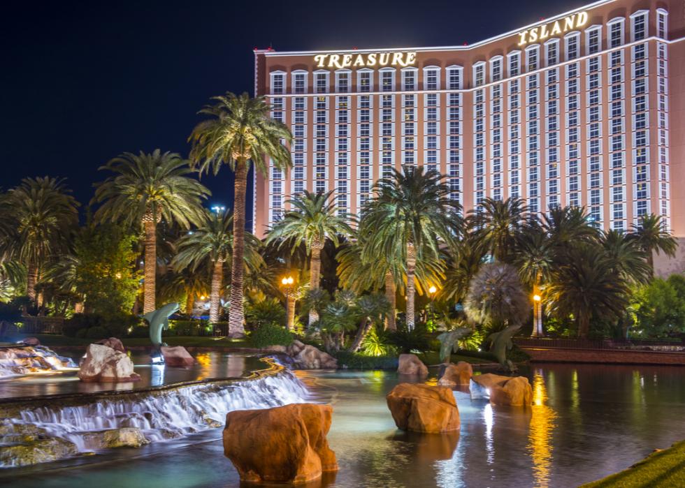 A view of the lagoon and main entrance of Treasure Island at night.